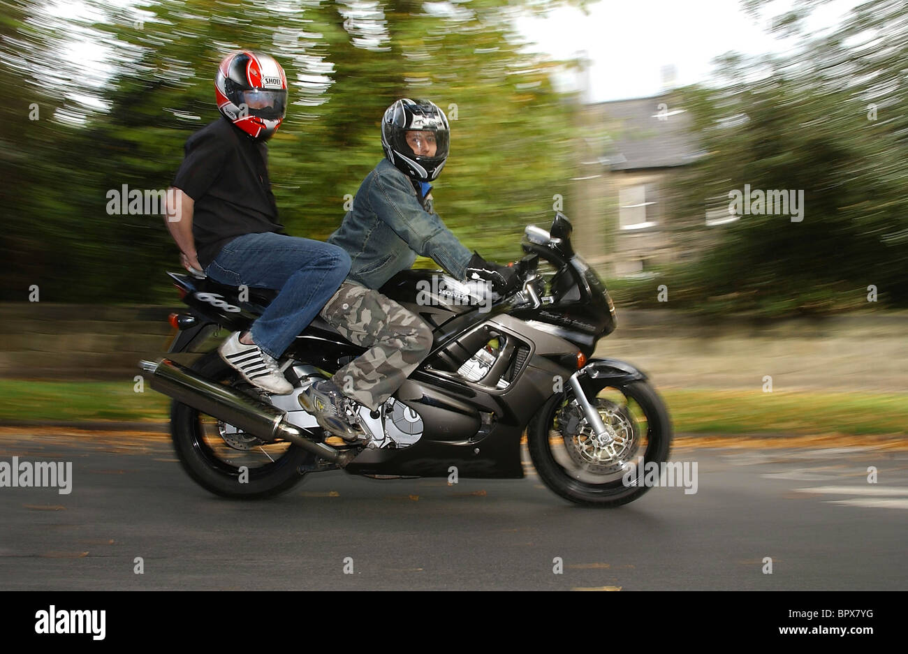 Piers Tucker on pillion wearing the visor display helmet on motorcycle