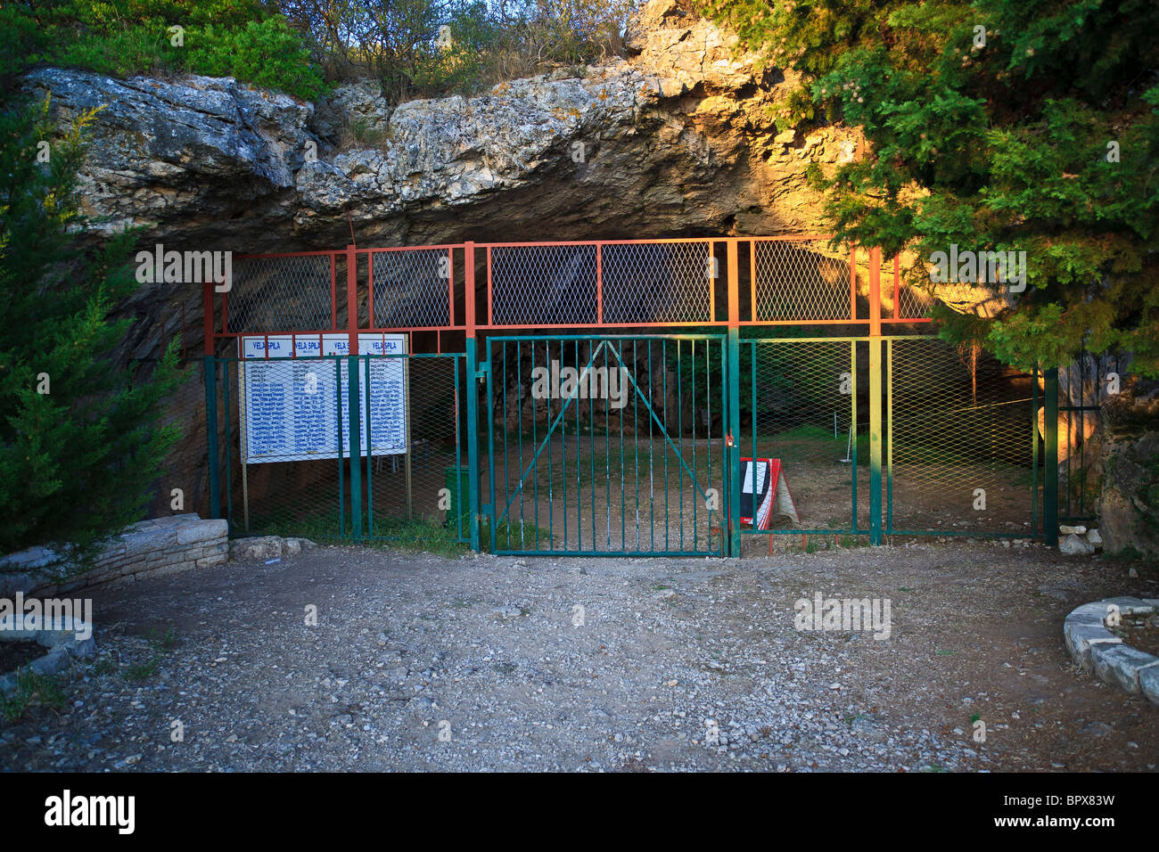 Gated entrance to the Vela Spila cave above Vela Luka on the Korcula Island  Croatia. Stock Photo