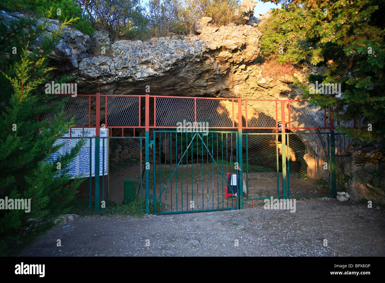 Gated entrance to the Vela Spila cave above Vela Luka on the Korcula Island  Croatia. Stock Photo