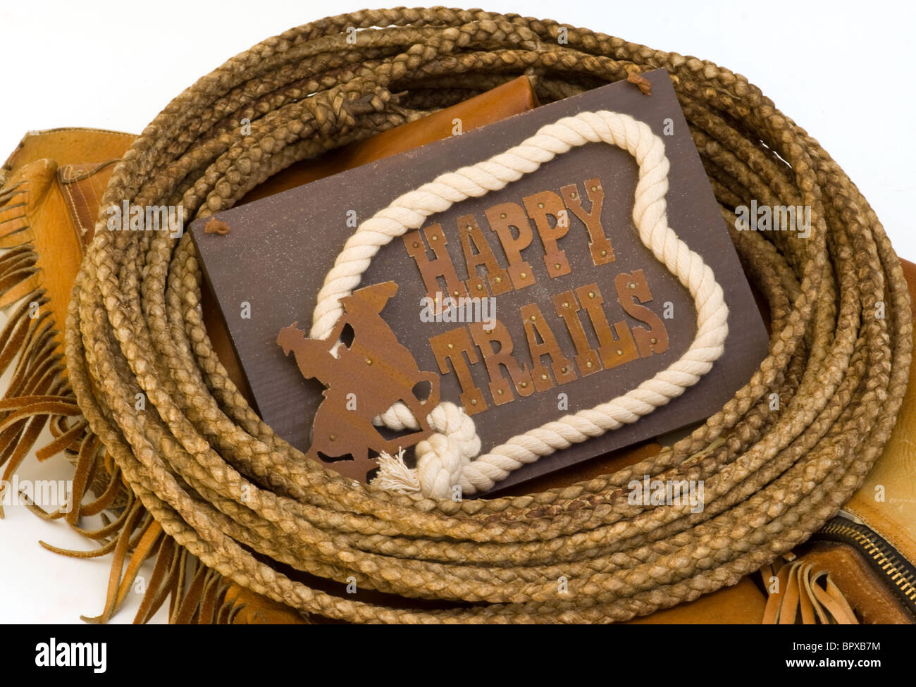 Happy trails message on rawhide rope and leather chaps Stock Photo 