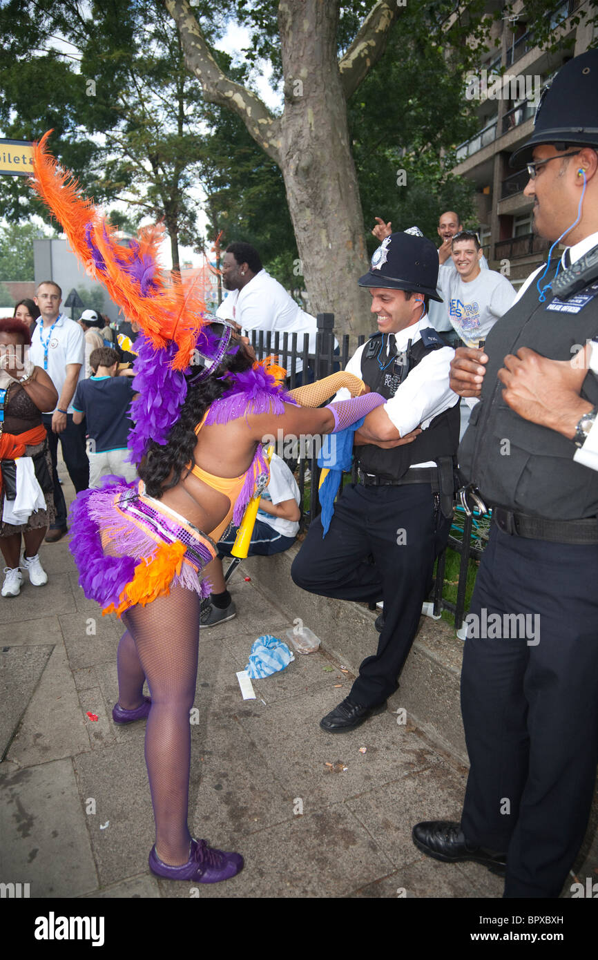 Notting Hill Carnival parade, dancing with a police officer, London,  England, United Kingdom Stock Photo - Alamy