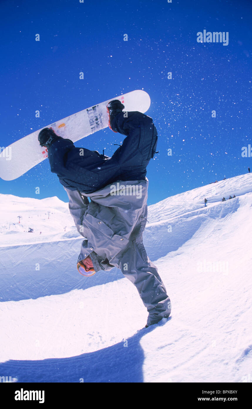 Snowboarder halfpipe handplant Stock Photo