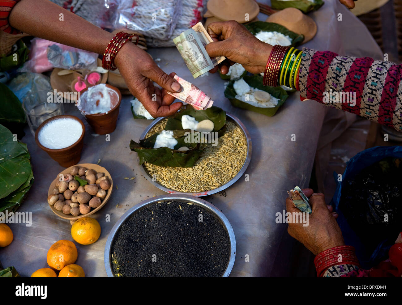 People buying religious offering items for Buddhist temple Bhaktapur Kathmandu Valley Nepal Asia Stock Photo