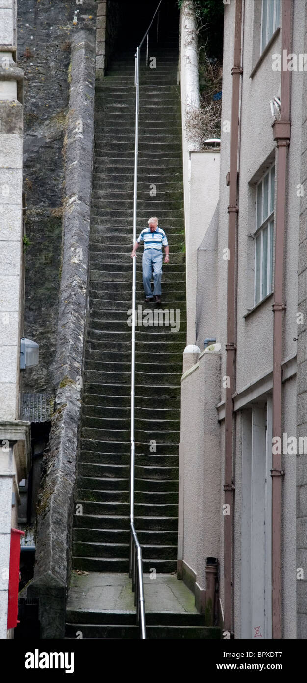 A man walks down the 'Jacob's Ladder' steps in Falmouth, Cornwall Stock