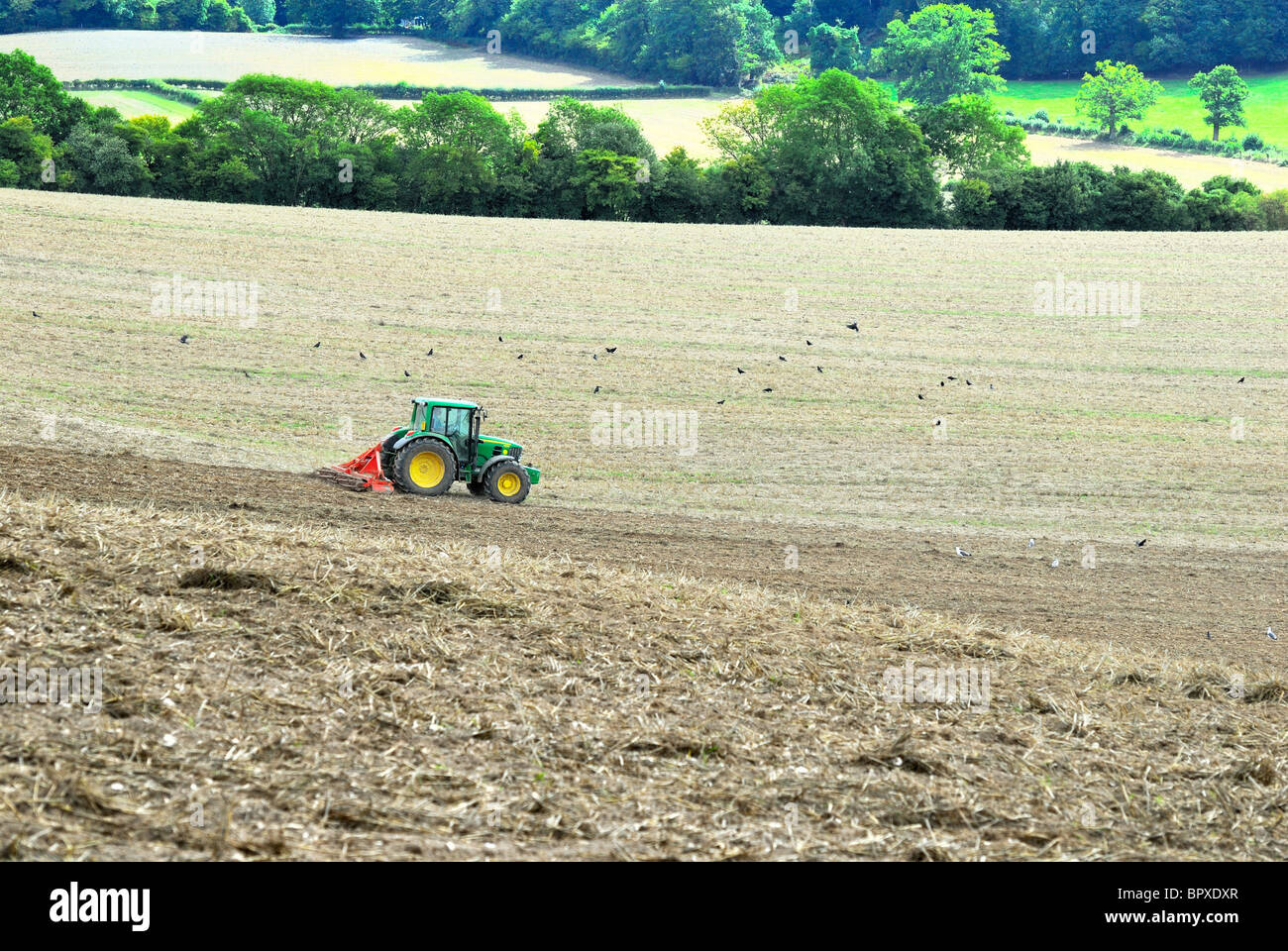 Tractor ploughing field on the Surrey Hills ,England Stock Photo