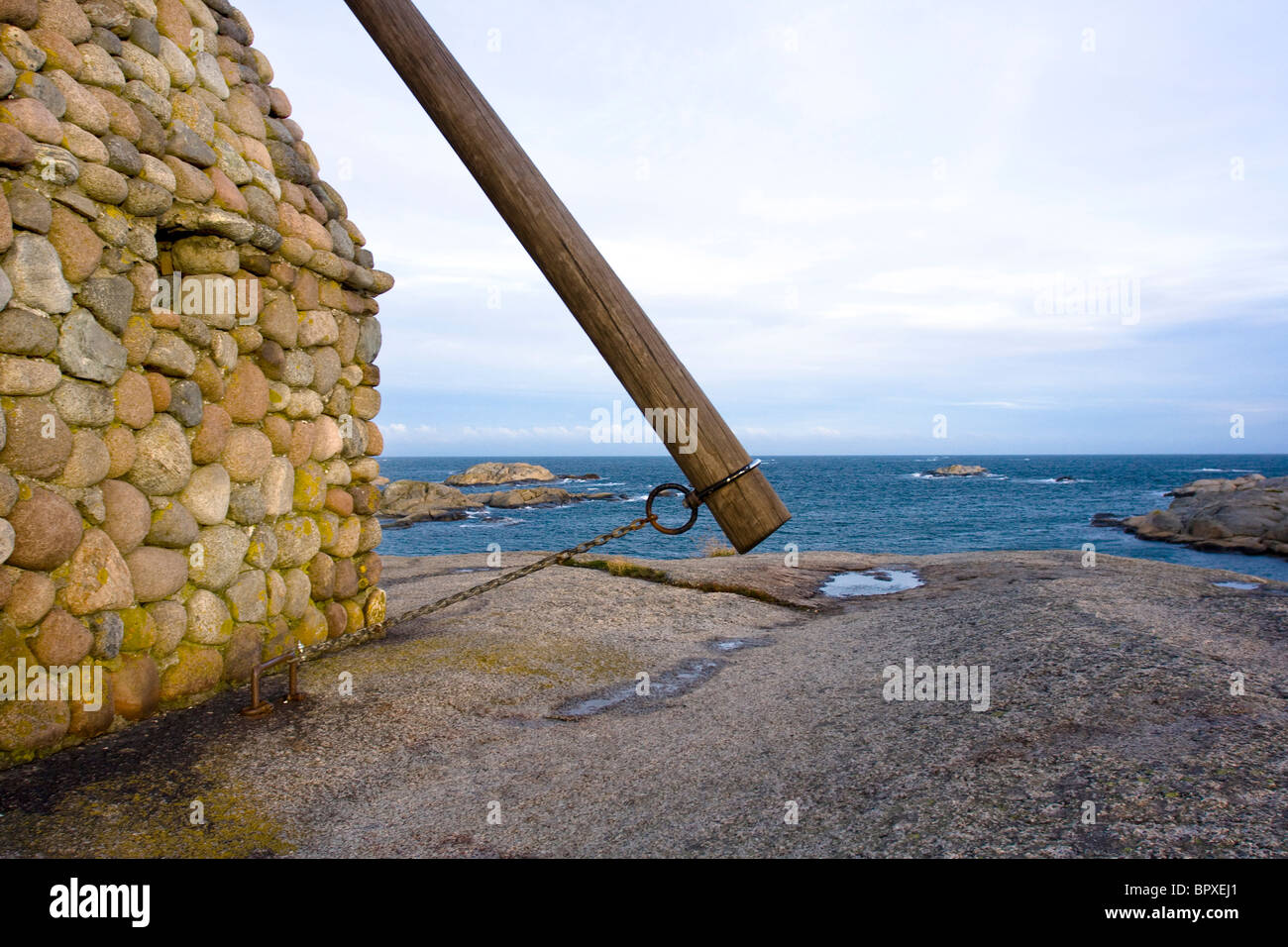 A traditional stone lighthouse on the coast at Verdens Ende, Tjome, Norway. Stock Photo