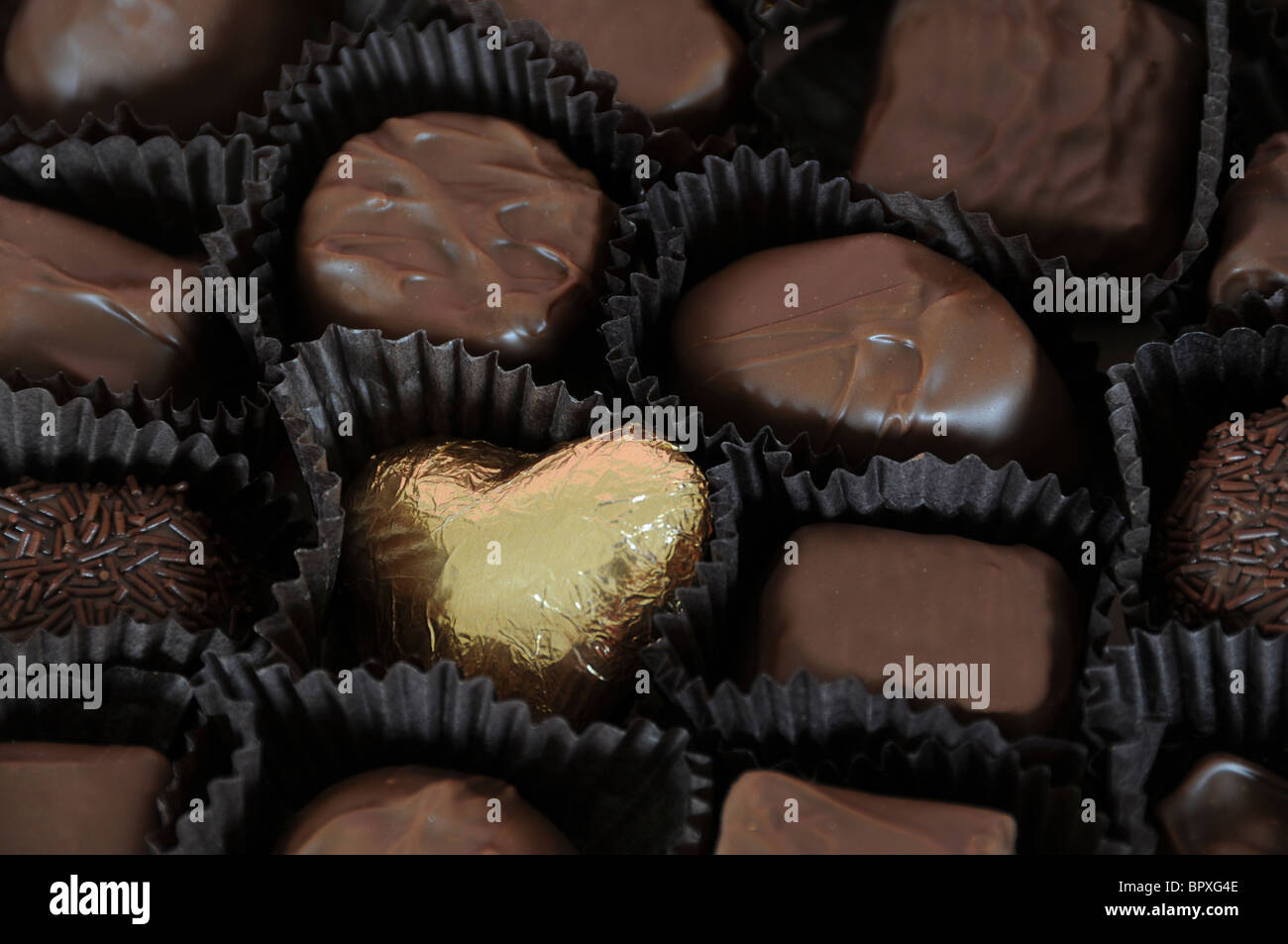Chocolates with Gold Heart Stock Photo Alamy