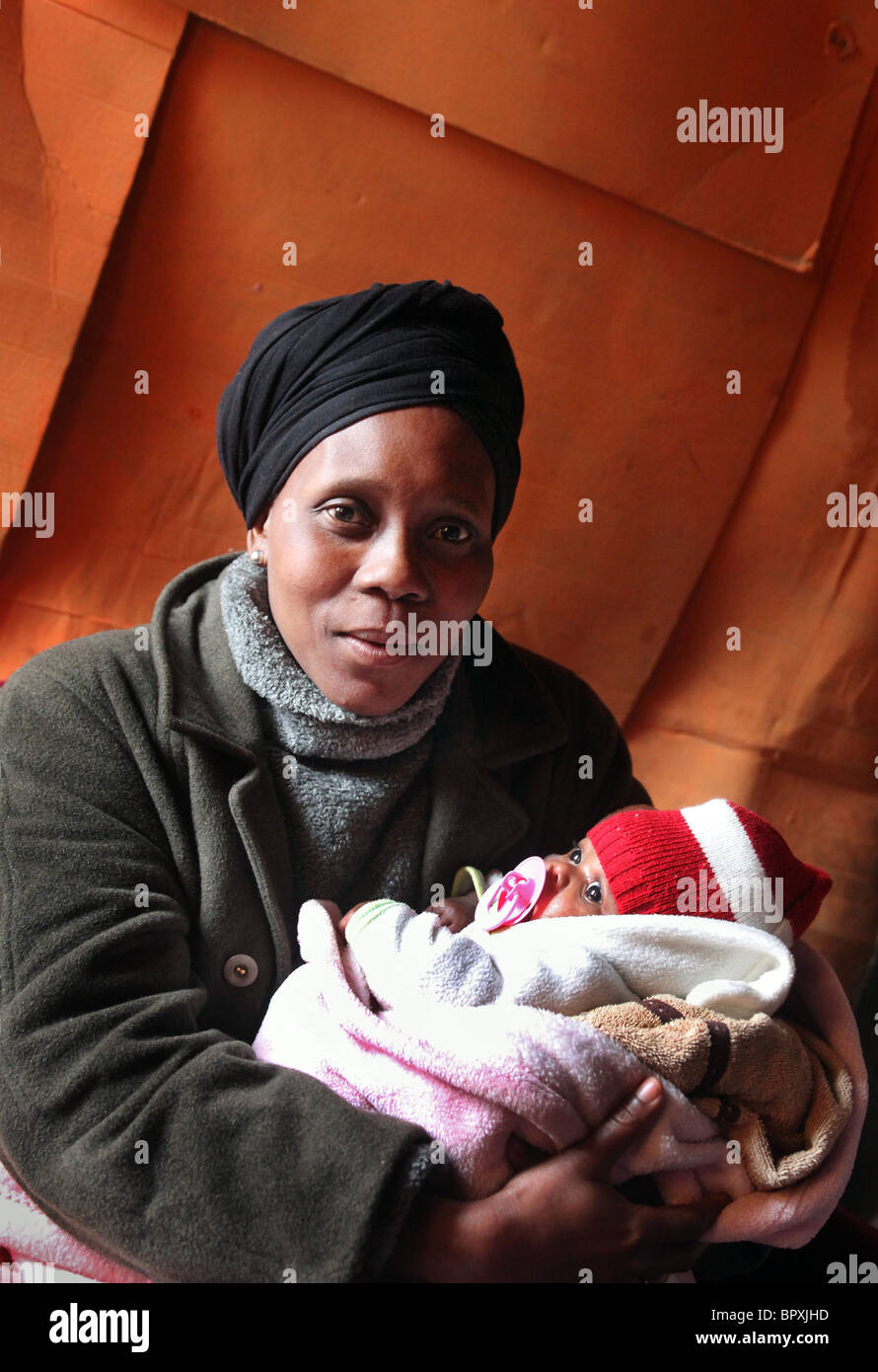 Mother with her baby in their hut in a Township in the vineyards of De Doorns, Western Cape, South Africa, , Hex Valley Stock Photo