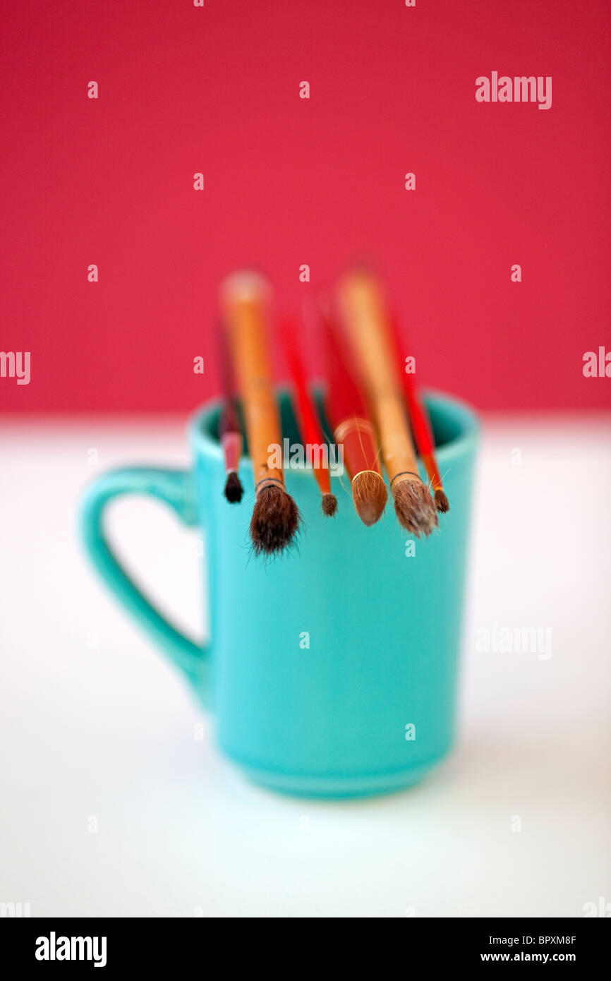 ARtists coffee cup with paint brushes Stock Photo