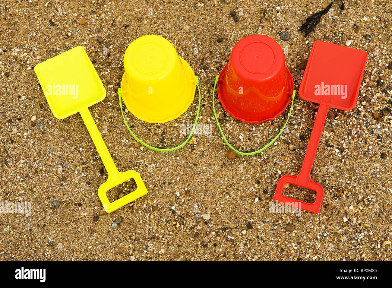 Colourful plastic bucket and spade on a beach Stock Photo Alamy