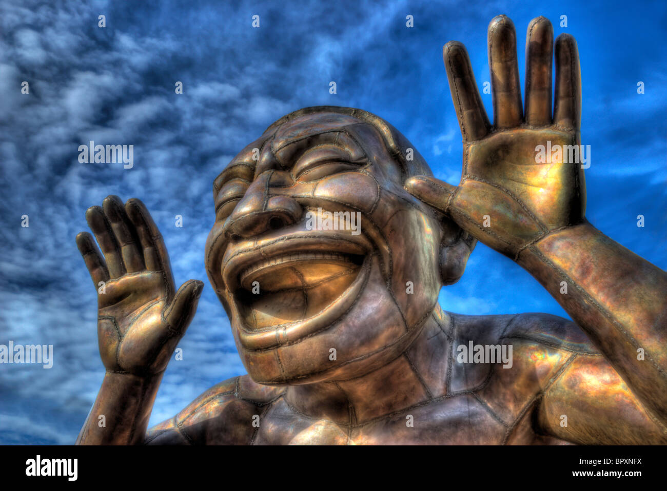 The laughing statue.One of an arrangement of tall bronze metal statues
