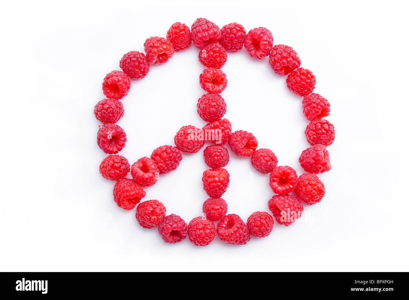 Raspberries arranged in the shape of the symbol of peace Stock Photo