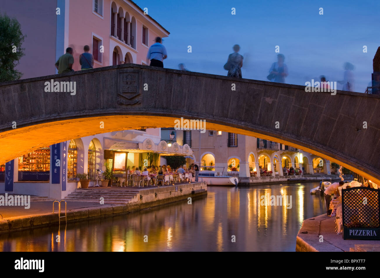 People walking on a bridge at night in Port Grimaud Stock Photo - Alamy