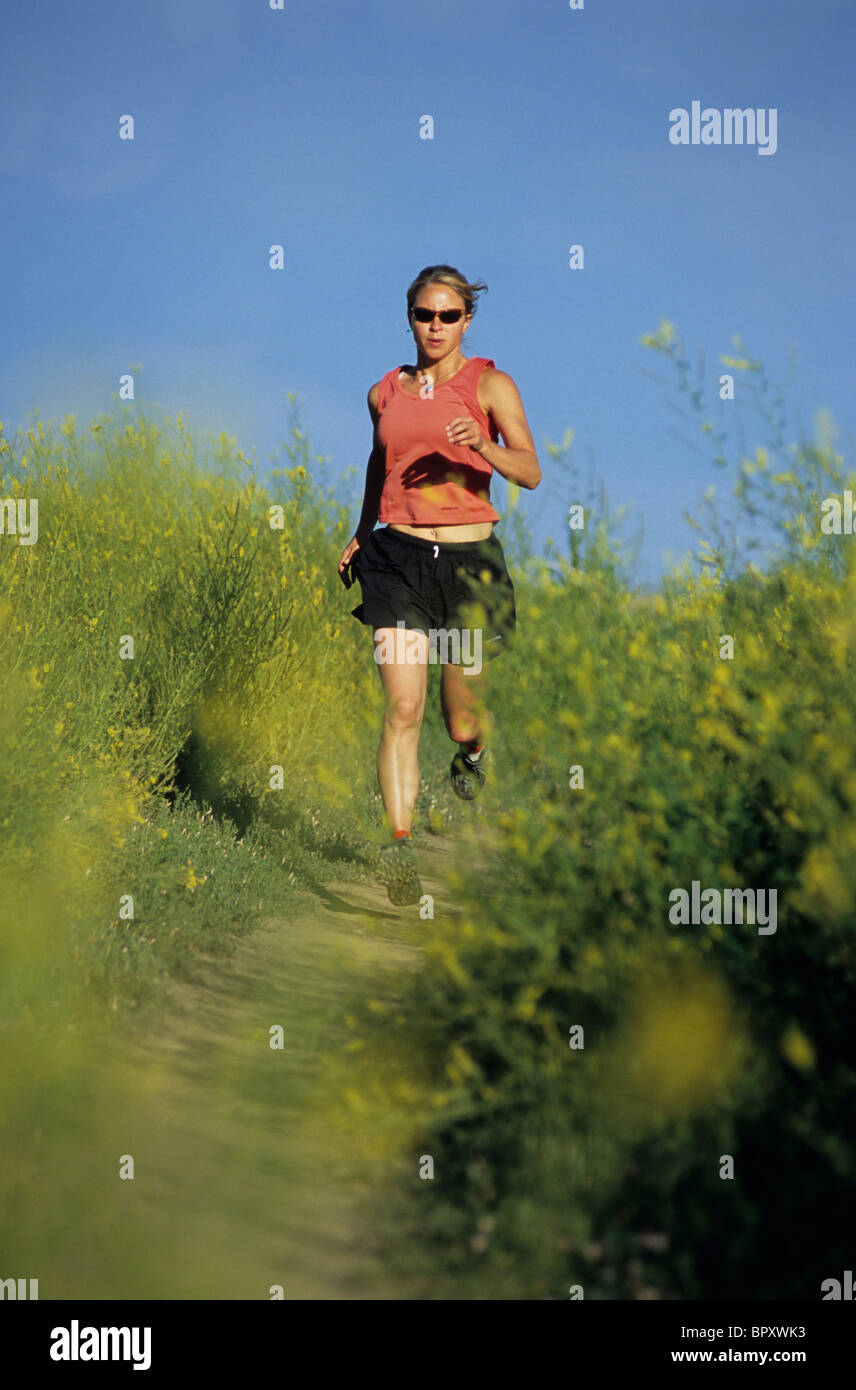 A woman running on the Lefthand trail near Boulder, CO. Stock Photo