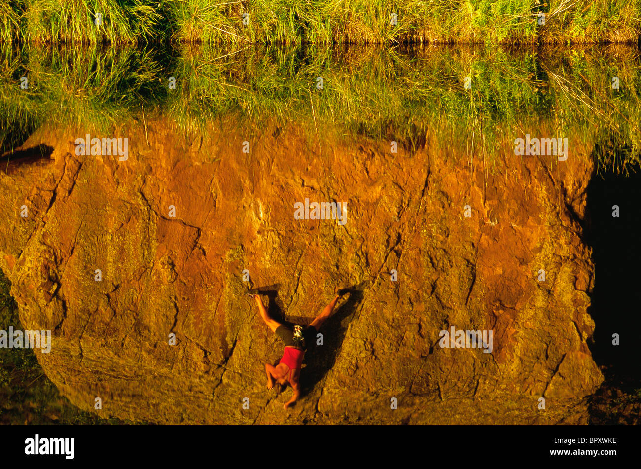 Reflection of a woman bouldering at the Scenic Boulder, CO. Stock Photo