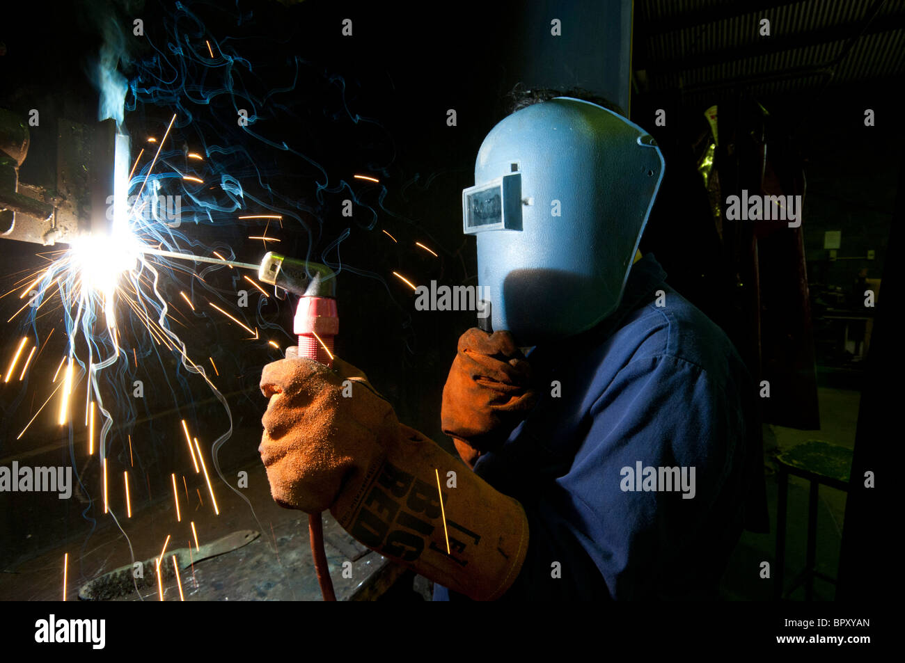 A high school student learning welding skills at a training centre Stock Photo