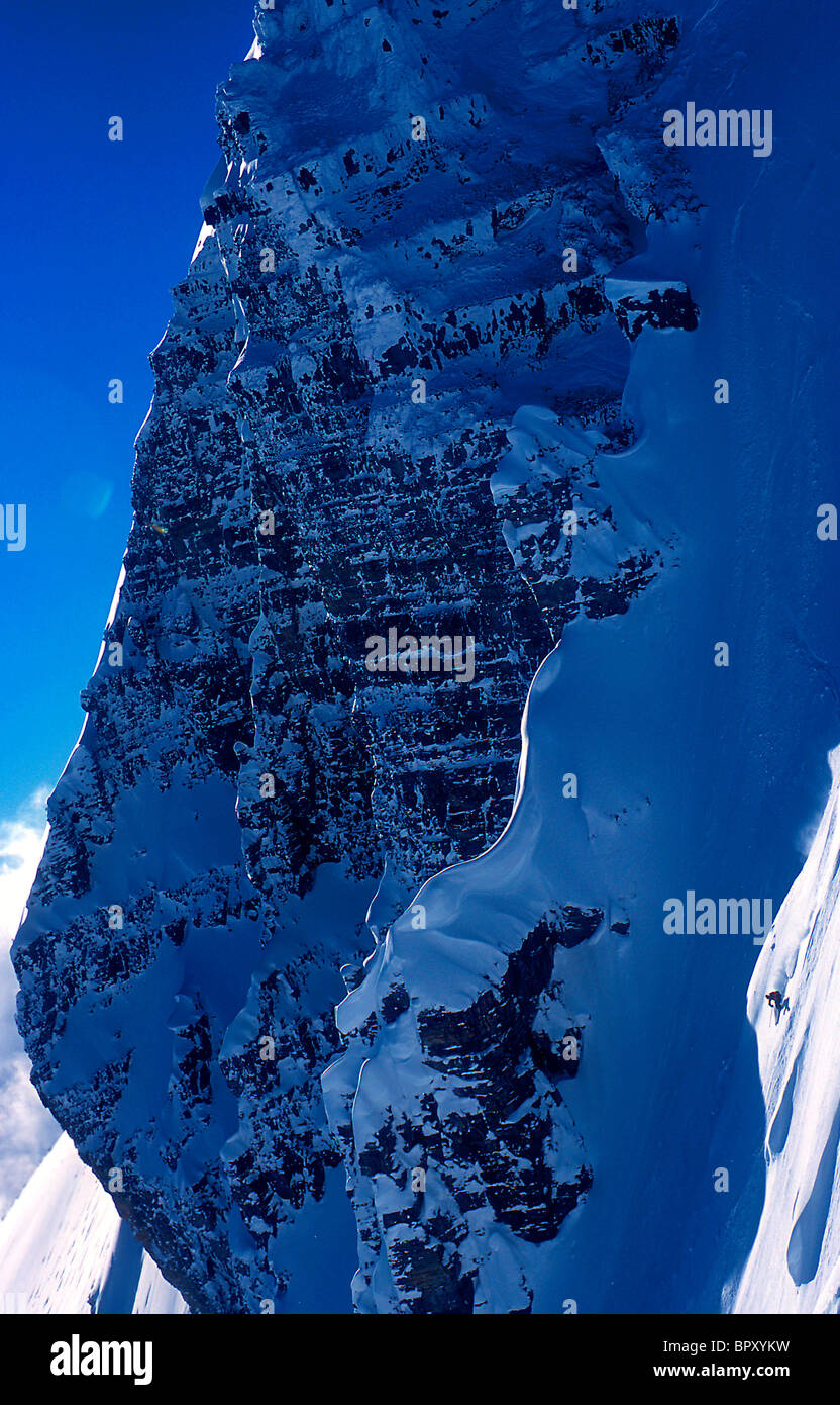 A skier drops from snowy cliff Stock Photo - Alamy