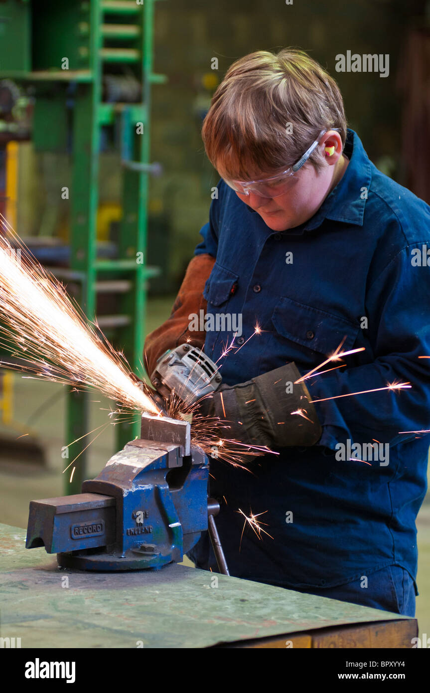 A high school student learning metal-working skills at a training centre Stock Photo