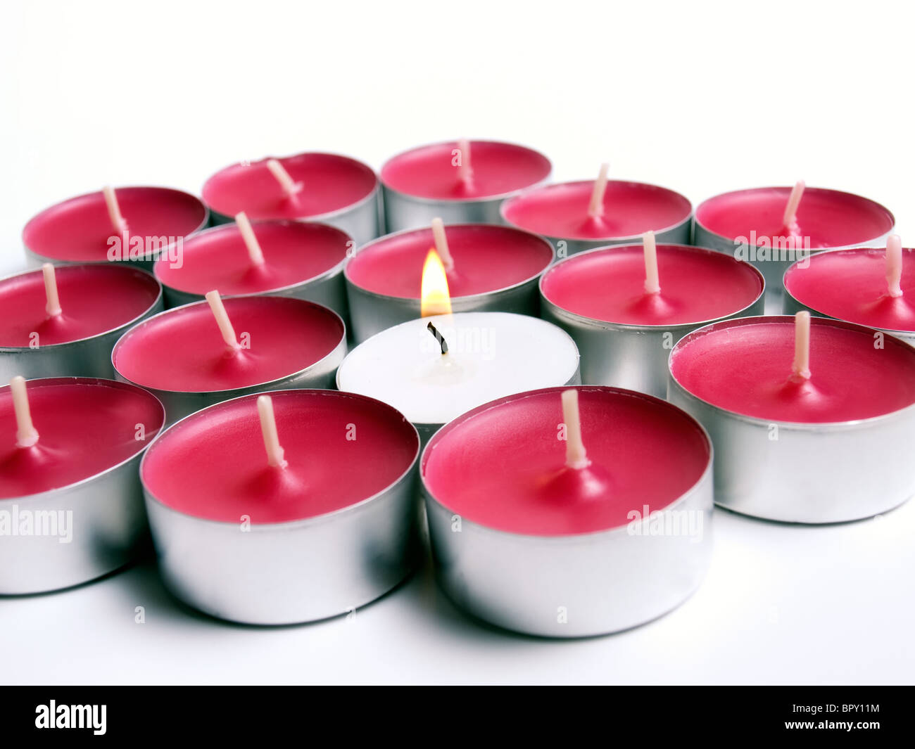 Many small candles on a white background. Stock Photo
