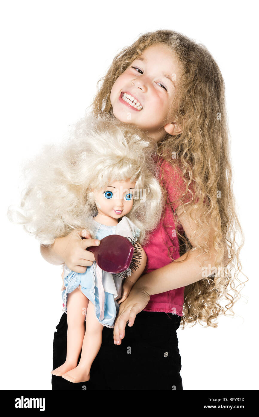 caucasian little girl portrait playing bonding with a doll isolated ...