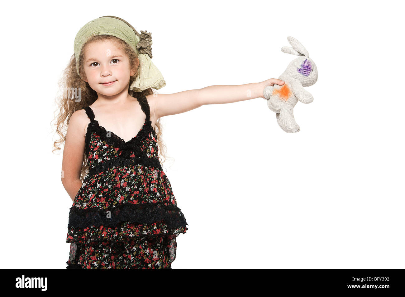 caucasian little girl showing rabbit cuddly toy isolated studio on white background Stock Photo