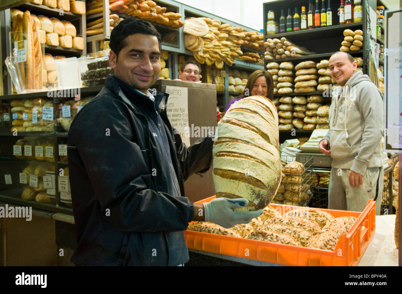 Man delivering crusty bread from a bakery in the early morning to