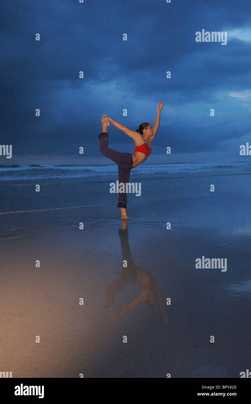Female performs yoga on the beach Stock Photo Alamy