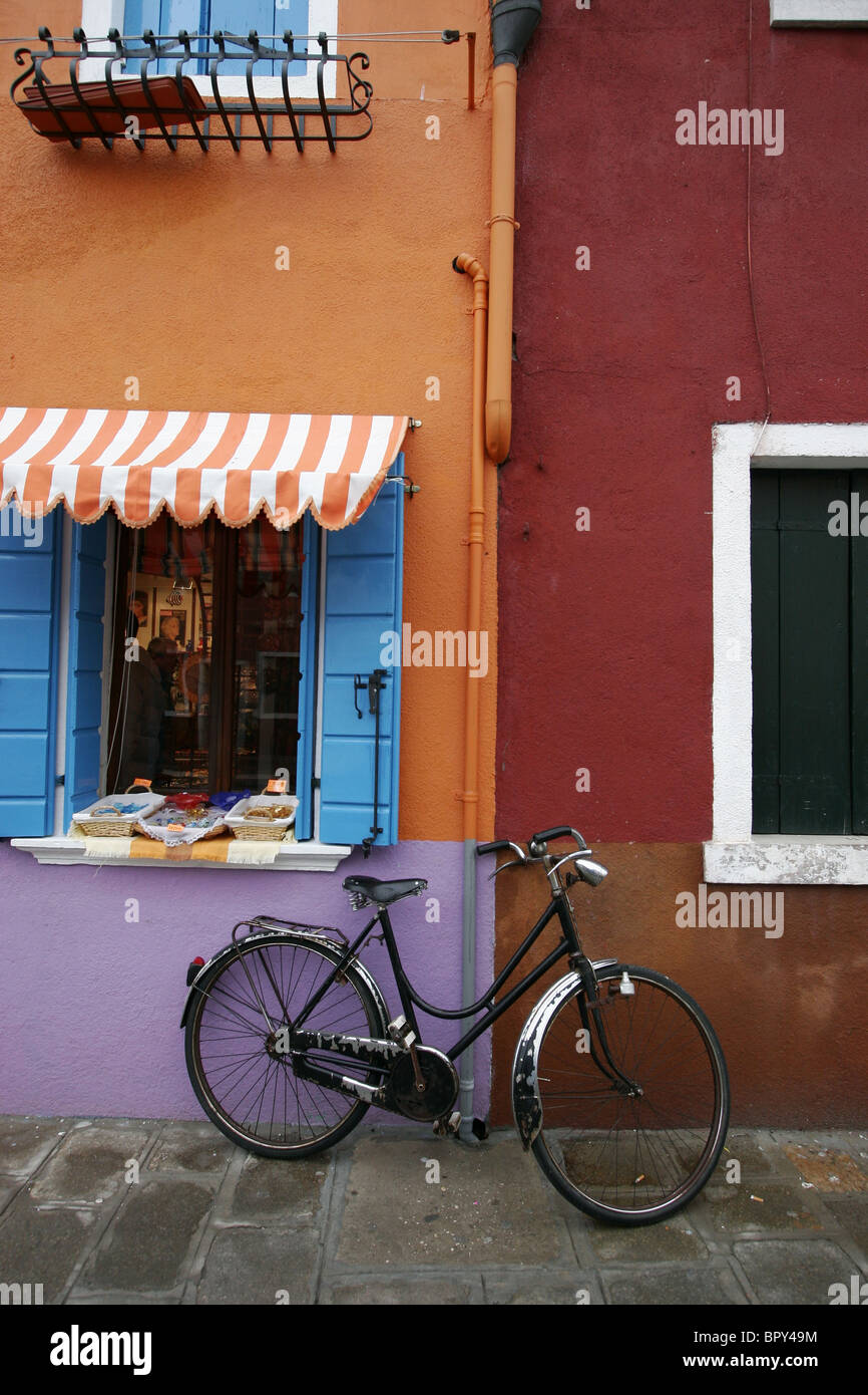 Colourful houses with bike against the wall Burano Italy Stock Photo