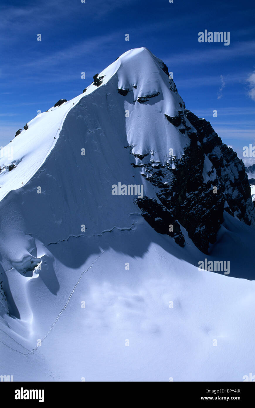 A mountain climbing team approaches the summit of Pequeno Alpamayo, Cordillera Real, Bolivia Stock Photo