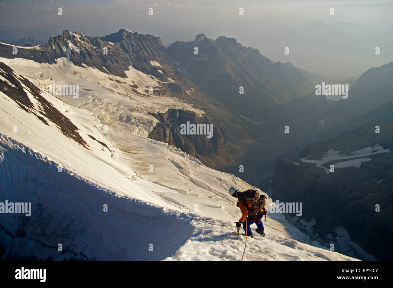 Mountain climber descending snow ridge, Canada Stock Photo - Alamy