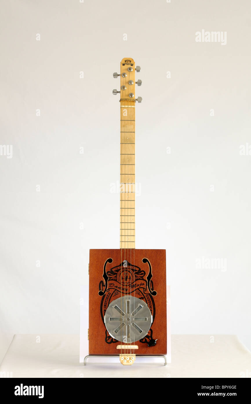 A Daddy Mojo 5 string cigar box guitar made in Canada in 2008 serial number 733 owned by Adam Gough from the band Traveller. Stock Photo