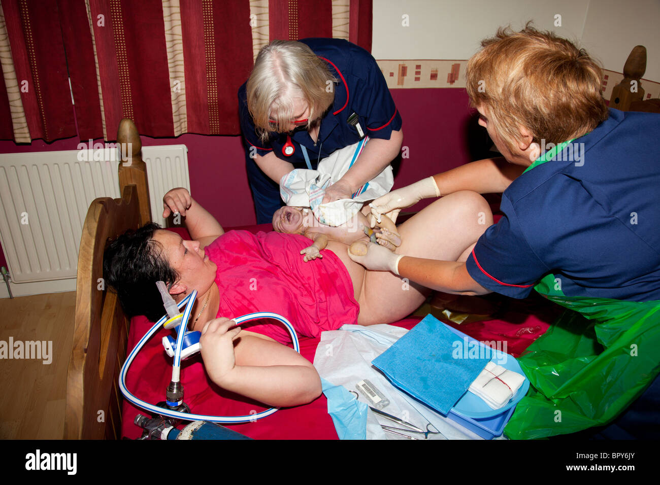 Baby Girl Being Born At Home In The Master Bedroom