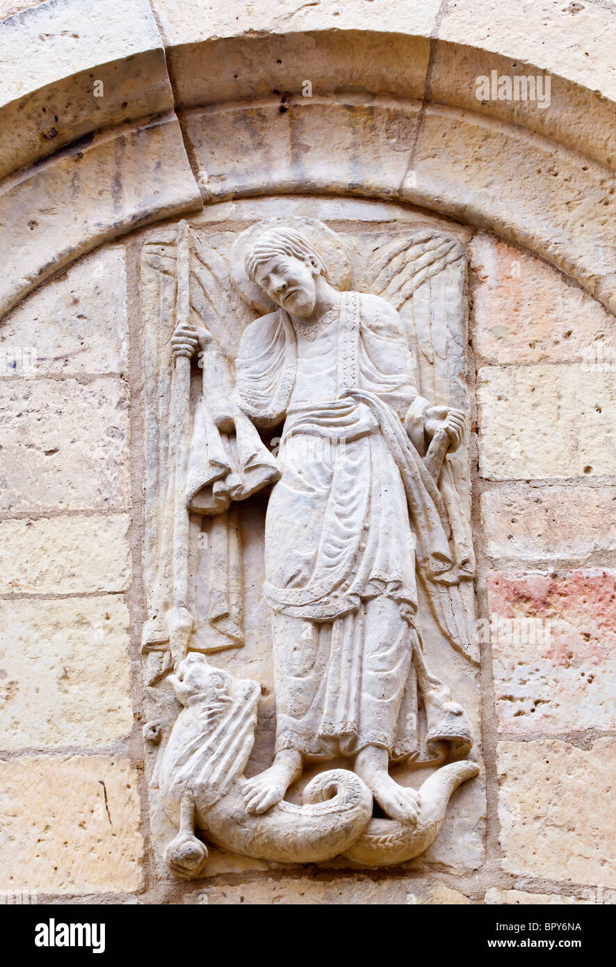 Segovia, Segovia Province, Spain. Statue on facade of Iglesia de San Miguel of Saint Michael wounding a dragon. Stock Photo