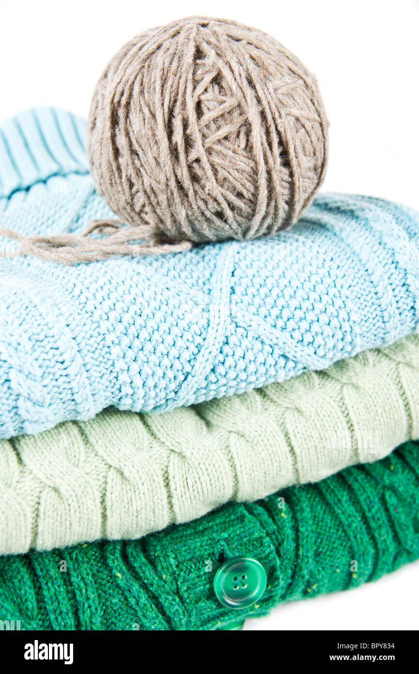Pile of sweaters and ball of yarn Stock Photo