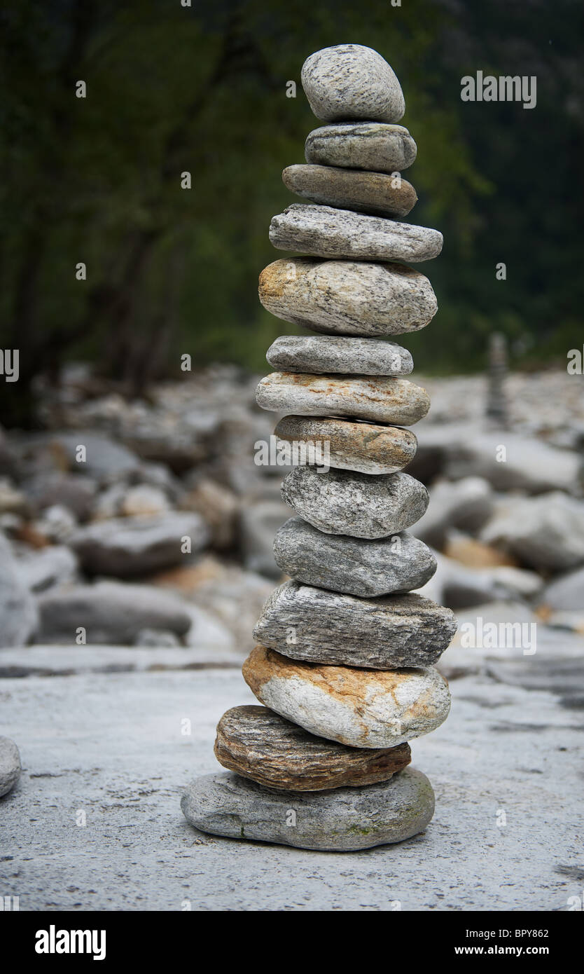 Granite Stones piled up to a forma tower in Ticino at the bank of the river Verzasca Stock Photo