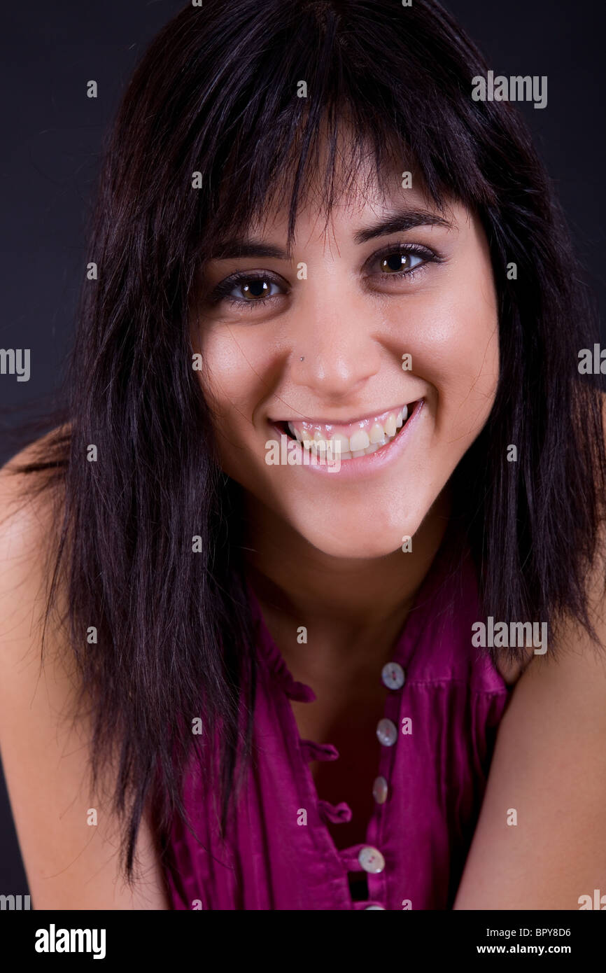 young beautiful brunette portrait against black background Stock Photo ...