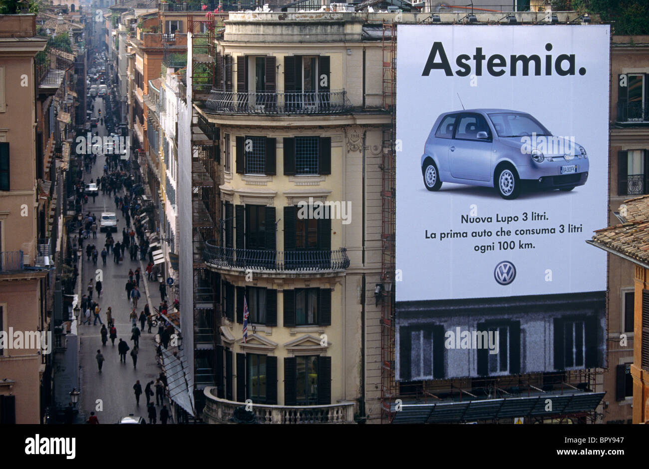 With a giant Volkswagen (VW) poster of their Lupo car in the foreground, an aerial view of Via dei Condotti. Stock Photo