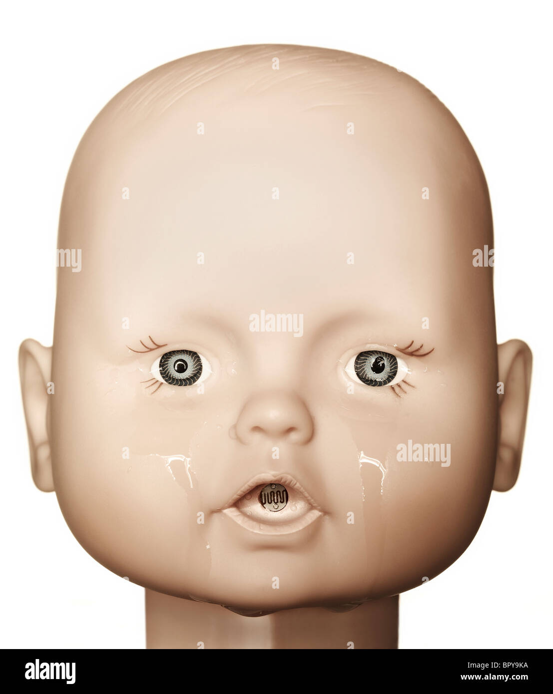 crying baby doll head on a white background Stock Photo