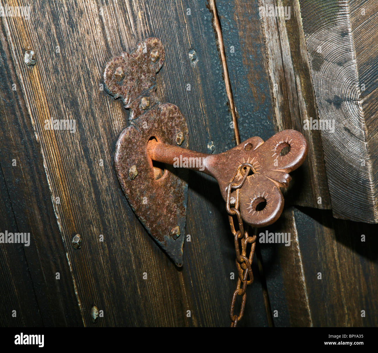 Close up historic church front door unique vintage key in keyhole of