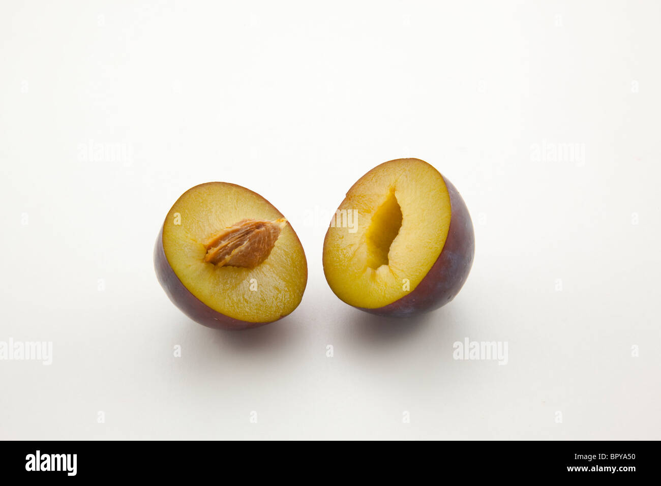 purple plum cut in half Stock Photo Alamy