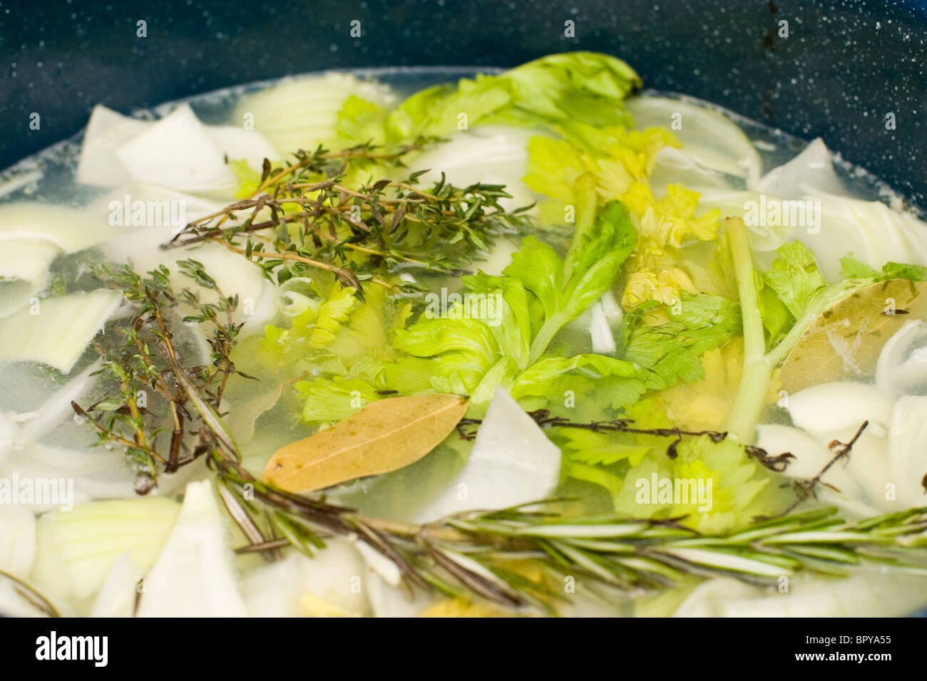 Herbs and vegetables in a pot. One of the steps in making homemade