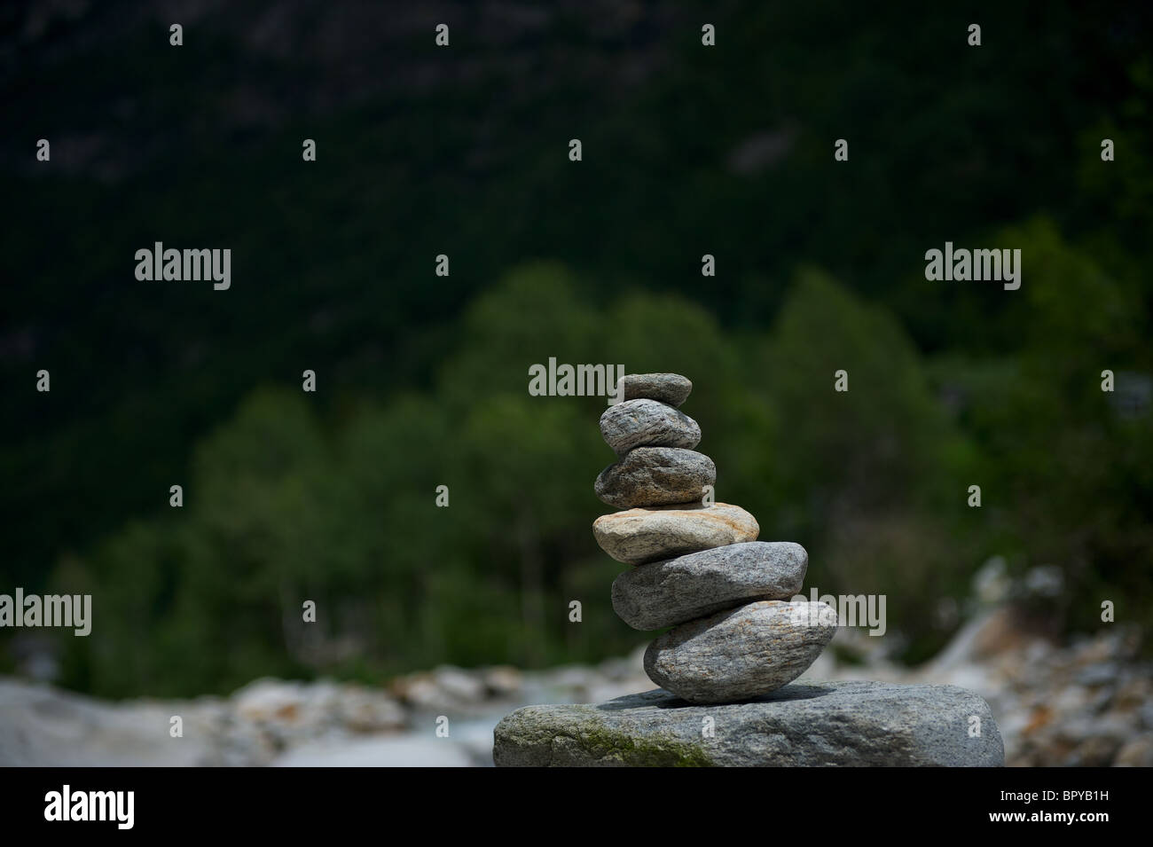 Granite Stones piled up to a forma tower in Ticino at the bank of the river Verzasca Stock Photo