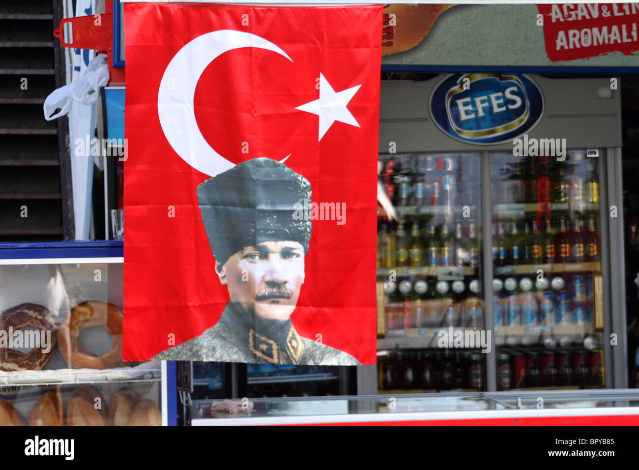 Turkish flag with portrait of Kemal Ataturk outside convenience store, Kas, Turkey Stock Photo