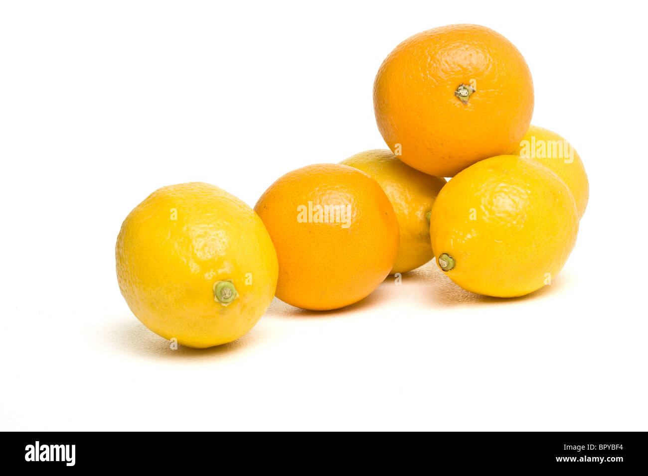 Vibrant Oranges and Lemons from low perspective isolated against white. Stock Photo
