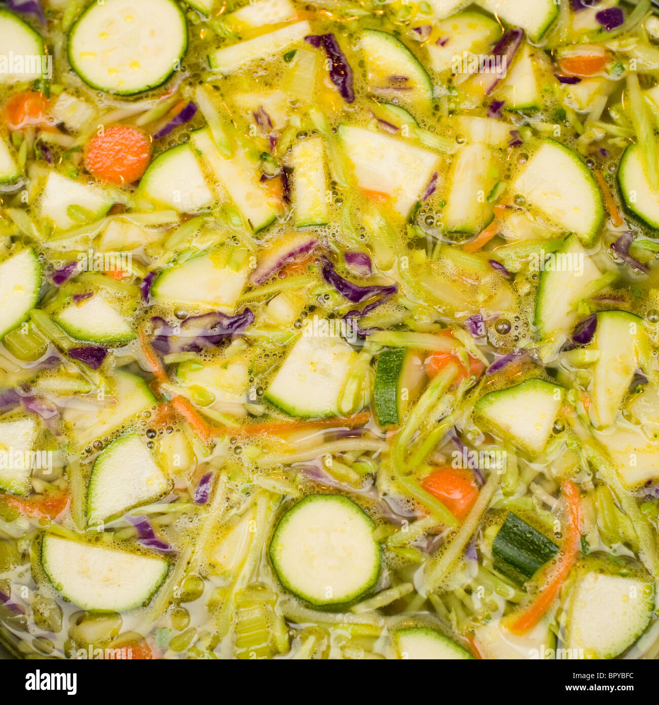 Vegetables cooking in chicken stock. One of the steps in making homemade chicken soup. Stock Photo
