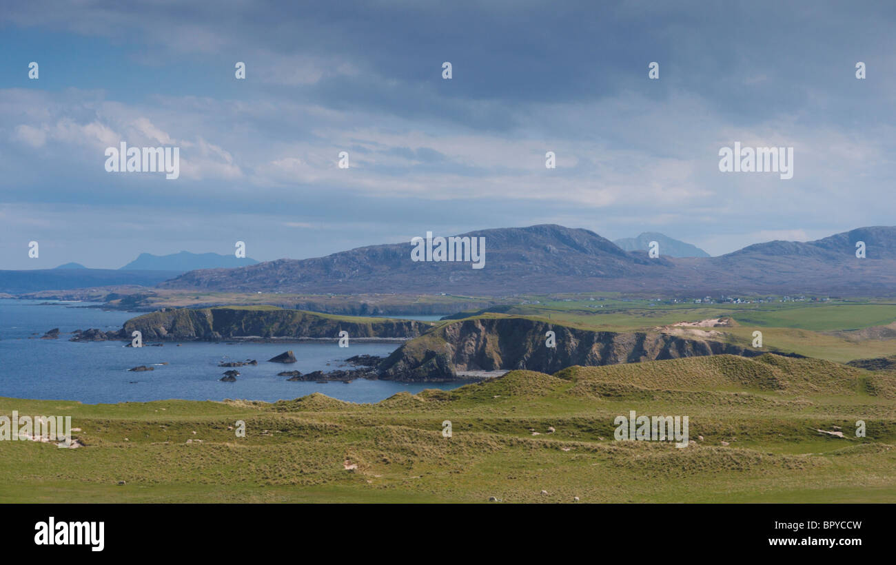 Looking along the coastline from Faraid Head towards Beinn Ceannabeinne, Ben Hope and Ben Loyal, Scottish Highlands, UK Stock Photo