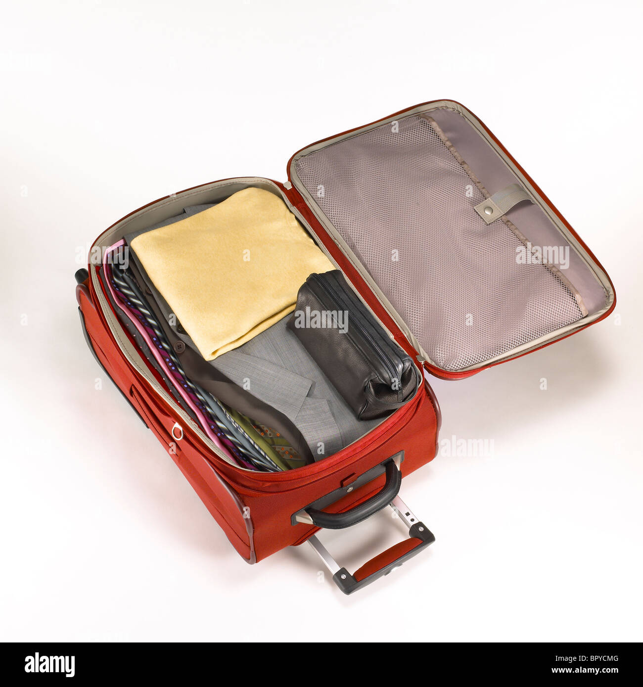A red carryon luggage with contents Stock Photo Alamy