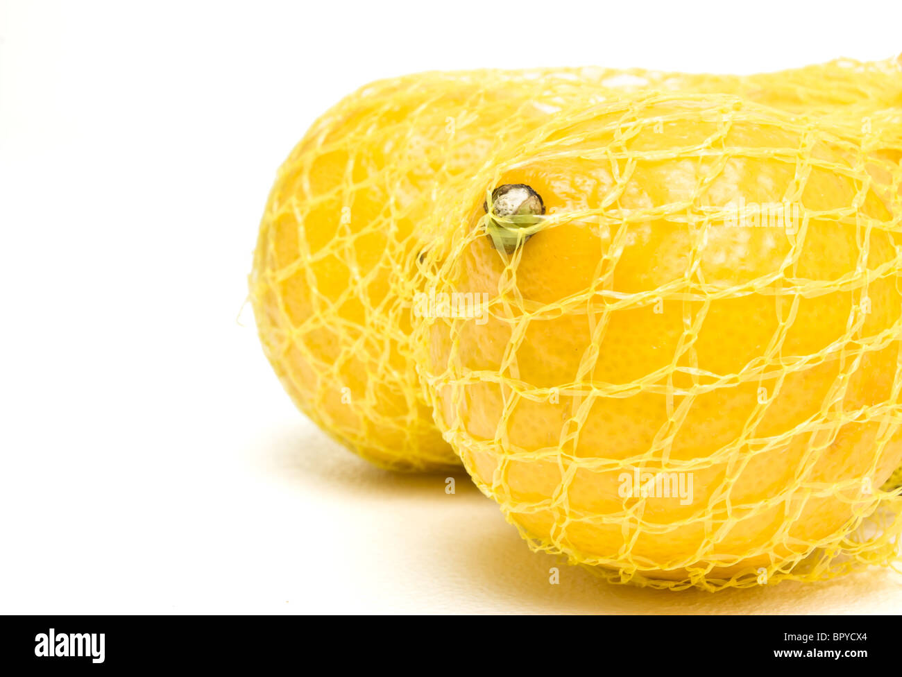 Lemon in a mesh bag. Stock Photo by Maliflower73
