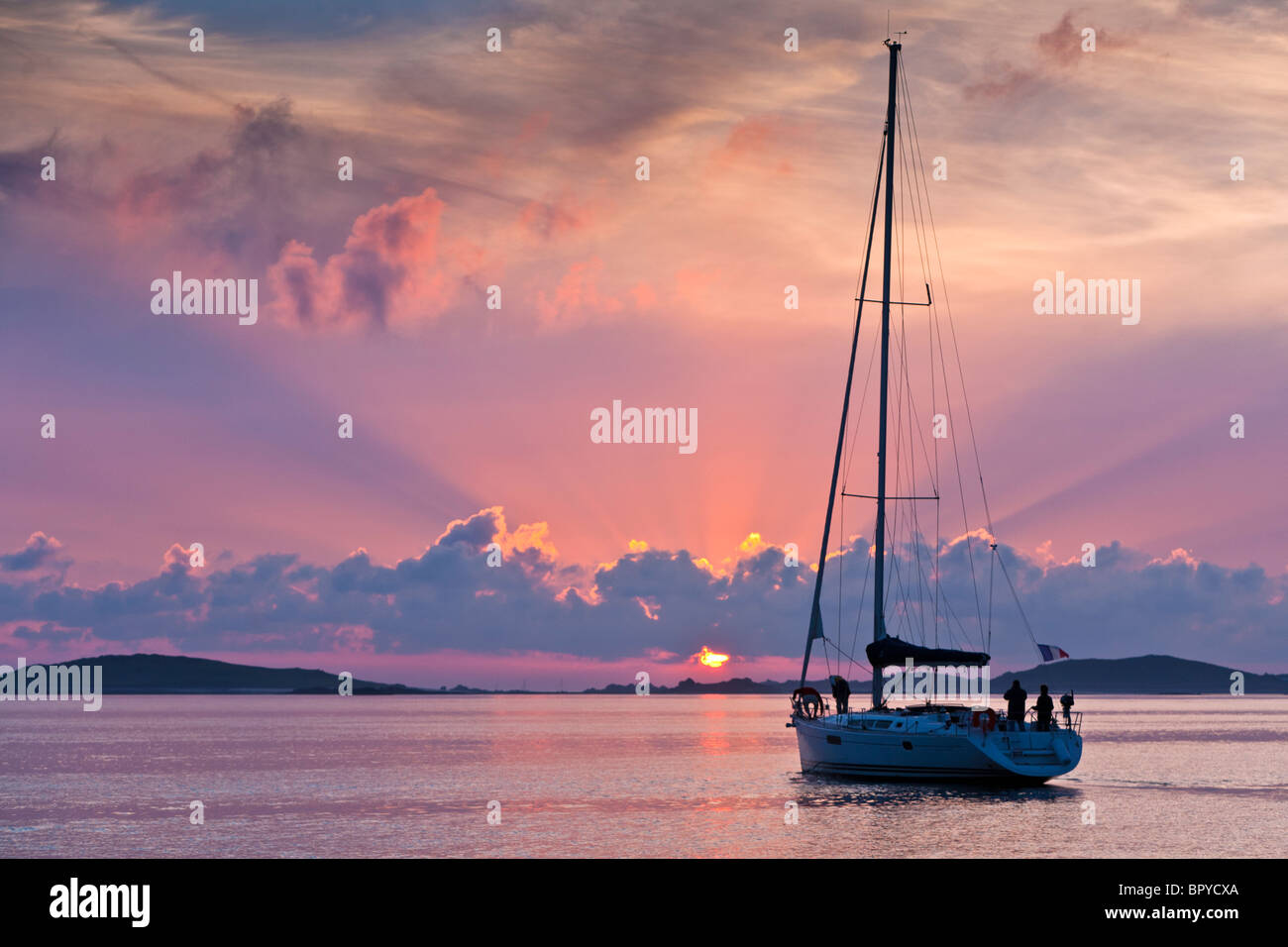 Yacht Silhouette at sunset locking towards Sampson and Tresco Isles of Scilly UK Stock Photo