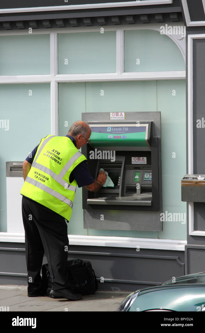 ATM sanitising at a bank in a U.K. city. Stock Photo